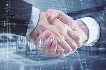 Close up of handshake with glowing candlestick forex grid chart on blurry office interior background. Financial growth, teamwork, trade and stock market concept. Double exposure.