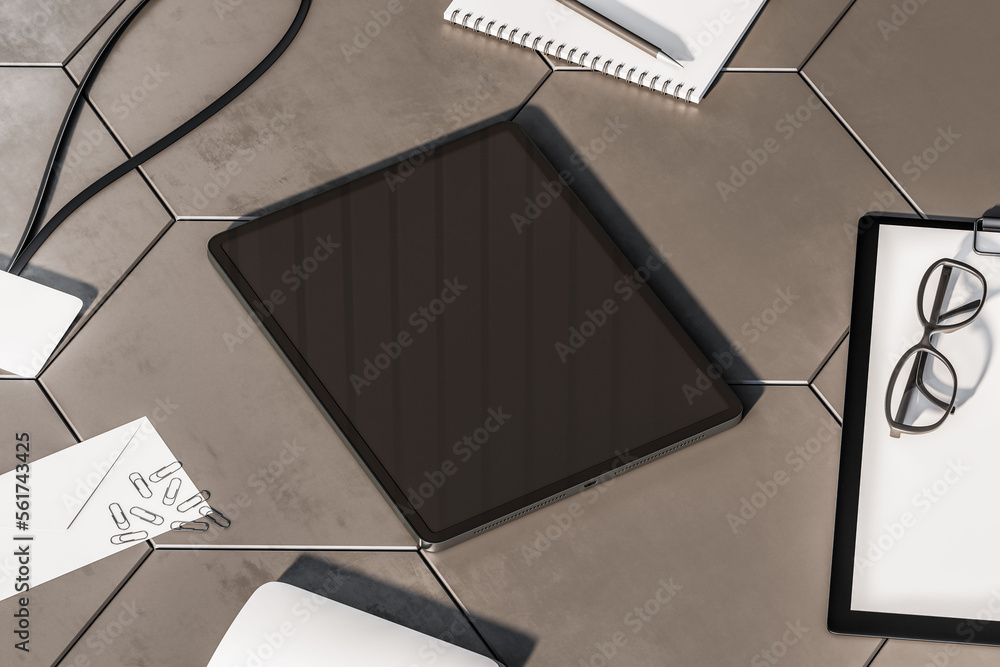 Poster Perspective view on modern digital tablet with blank dark screen and space for your logo or text on concrete grey tiles surface among office tools and glasses. 3D rendering, mock up
