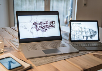 Laptops with design of sustainable resources on screen in office