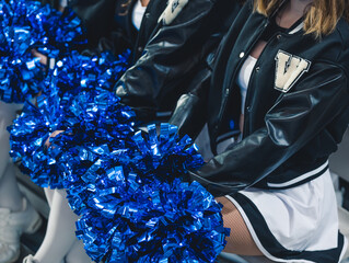 Close-up shot. Blue pom-poms held by cheereladers. Sport concept. High quality photo