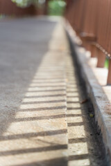 Obraz premium a shadow of a railing. Empty walkway in the center.