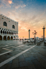 St. Mark's Square (Piazza San Marco) of Venice at dawn with people walking around