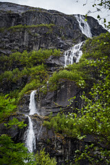 Fototapeta na wymiar Waterfall cascade on a steep fjord landscape in Norway