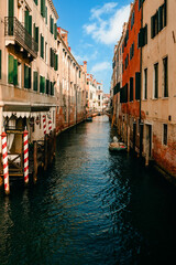 Characteristic canal of Venice with blue sky with clouds