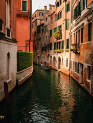 Fototapeta na wymiar Characteristic canal of Venice with gondolier while sailing