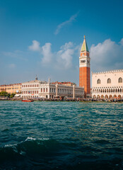 Fototapeta na wymiar The bell tower of San Marco in Venice taken from the sea with blue sky and clouds