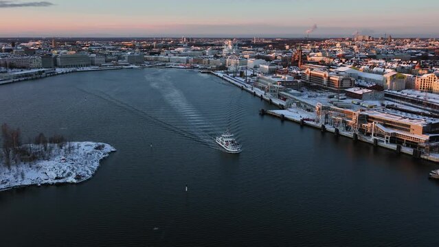 Aerial view in front of a ferry leaving Helsinki, winter sunset in Finland