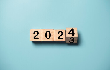 Flipping of 2023 to 2024 on wooden block cube for preparation new year change and start new...
