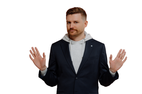 Strict red haired man in casual clothes spreading palms sideways and saying no