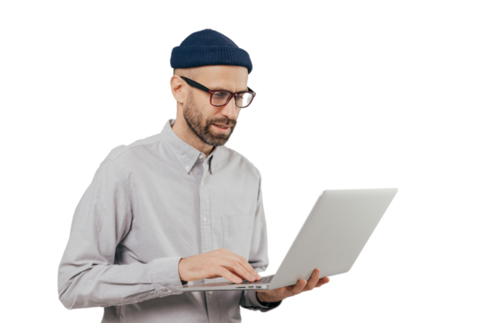 Professional IT developer downloads files, chats online in social networks, bloggs and surfes internet webpages wears formal shirt, stands against grey background. Technology and people concept