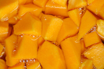 Slices, pumpkin in boiling water in a pot. Cooking healthy, vegetables. Soft focus.