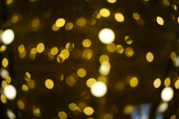 Abstract bright background, bokeh of burning yellow light bulbs.