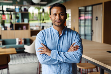 Young middle-eastern businessman in formal wear working at office