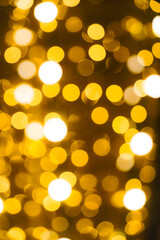 Abstract bright background, bokeh of burning yellow light bulbs.