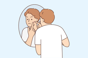 Young man stressed with pimple on face 