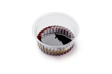 Plastic bowl with unagi sauce on white background