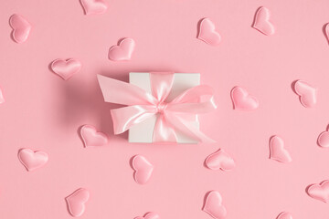 Valentine's Day concept.Top view of composition of pink confetti and  heart-shaped gift box with...