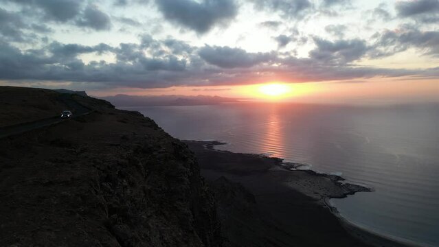 Lanzarote, Canary islands , Spain, Europe - Amazing street car road by the sea during the sunset in Mirador del Rio in north of Lanzarote biosfera reserve - journey and tourist attraction - Graciosa 