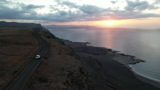 Lanzarote, Canary islands , Spain, Europe - Amazing street car road by the sea during the sunset in Mirador del Rio in north of Lanzarote biosfera reserve - journey and tourist attraction - Graciosa 