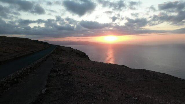 Lanzarote, Canary islands , Spain, Europe - Amazing street car road by the sea during the sunset in Mirador del Rio in north of Lanzarote biosfera reserve - journey and tourist attraction - Graciosa 