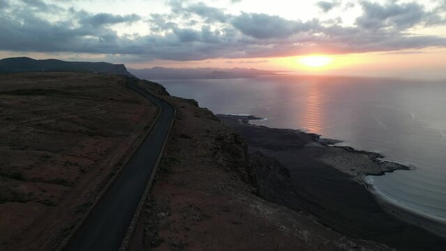 Lanzarote, Canary islands , Spain, Europe - Amazing street car road by the sea during the sunset in Mirador del Rio in north of Lanzarote biosfera reserve - journey and tourist attraction - Graciosa 