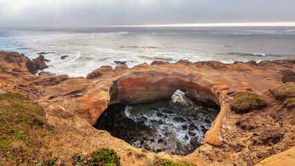 Devils Punchbowl Arch in Devils Punchbowl State Natural Area on the US West Coast in Oregon
