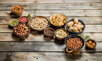 Obraz na płótnie Canvas Assortment of different nuts in bowls.