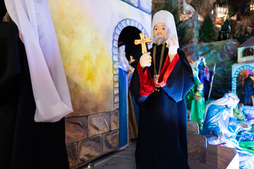 Christmas nativity crib scene in church. Patriarch doll.