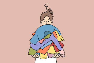 Confused young woman holding stack of dirty clothes. Confused unhappy girl with pile of clothing. Laundry day. Vector illustration. 