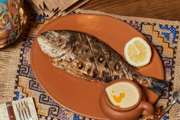 Grilled dorado with vegetables. Grilled fish. Top view.