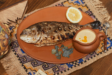 Grilled dorado with vegetables. Grilled fish. Top view.