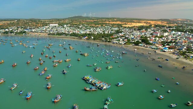Hundreds boats anchored in sunny moring. This is bay for boats avoid rainy season storms. Asia fishing boats. Fishing village in Mui Ne, Vietnam. Landscape hundreds of boats on beautiful Vietnam Sea