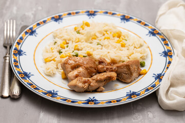 chicken fillet baked with sauce and boiled rice with vegetables