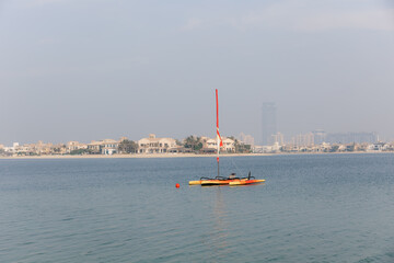 The view from Palm Jumeirah Beach to the city limits. Bright sunrise, sunshine in the frame. 