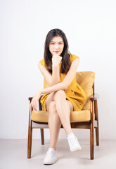 Image of young Asian woman sitting on chair
