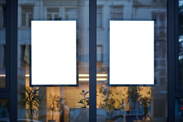 Blank window poster template. Promotional banner on the store, office window mock up. Blurred...