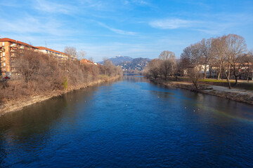 Fototapeta na wymiar River Po in Turin . Riverside residential houses . Torino riverside scenery 