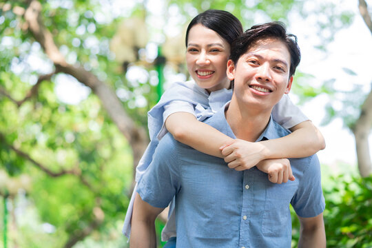 Image of young Asian couple outside