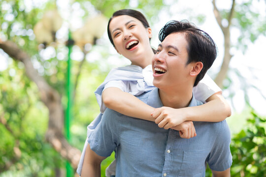 Image of young Asian couple outside