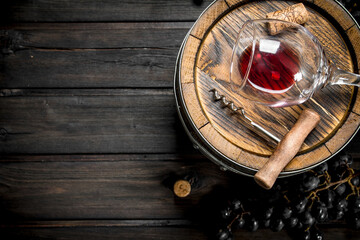 Wine background. Barrel with red wine and grapes.