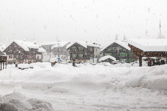 Bad weather and heavy snow in the mountains. Mountain village in winter. Macugnaga, main square, Italy, an important ski resort at the foot of Monte Rosa in the europeans Alps