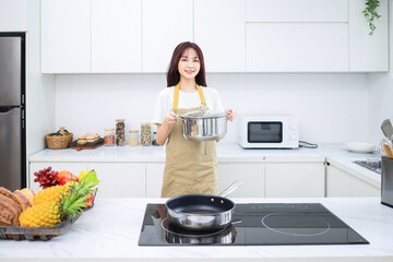 Image of young Asian woman in the kitchen
