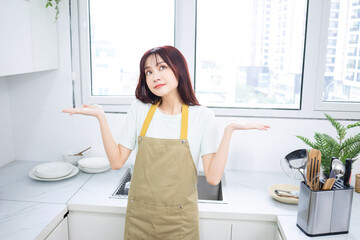 Image of young Asian woman in the kitchen