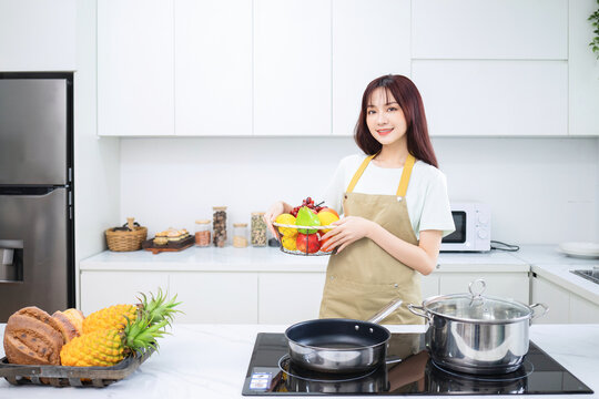 Image of young Asian woman in the kitchen