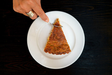 Eating flaó, a typical Ibiza dessert. Traditional Balearic cheese cake