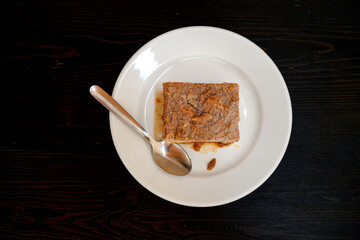 Eating greixonera, a typical Ibiza dessert. Traditional Ibiza ensaimada cake