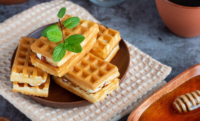 Breakfast with waffles, honey and coffee