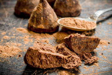 Chocolate candy truffles with cocoa powder.