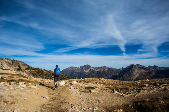 A young man hikes through the colorful larch trees in the Pasayten Wilderness on the Pacific Crest Trail (PCT) in Washington.