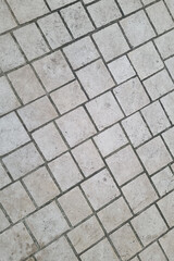 Gray paving slabs in the city. Hiking trail.